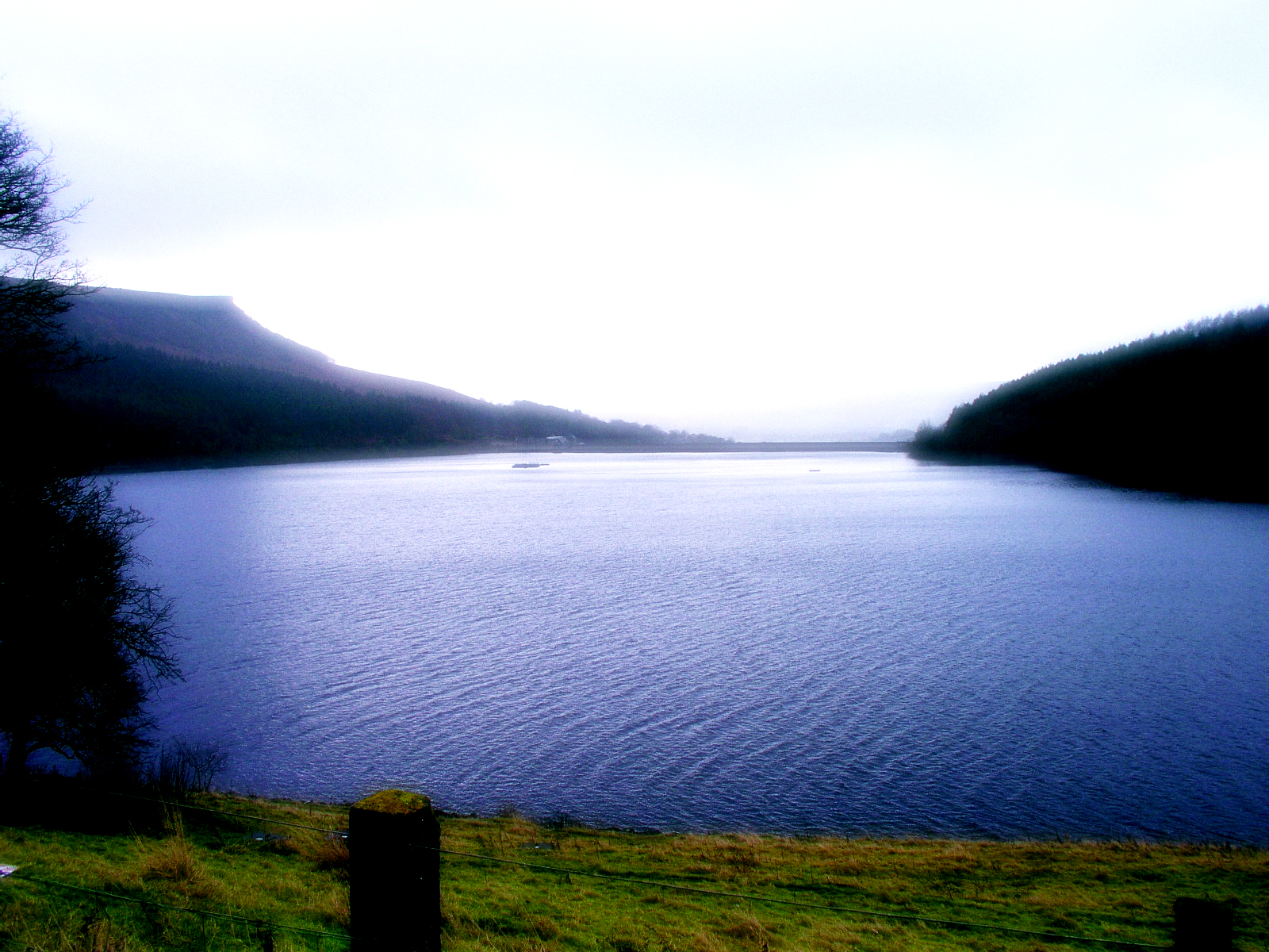a large body of water surrounded by hills