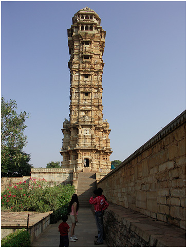 some people standing near a very tall tower