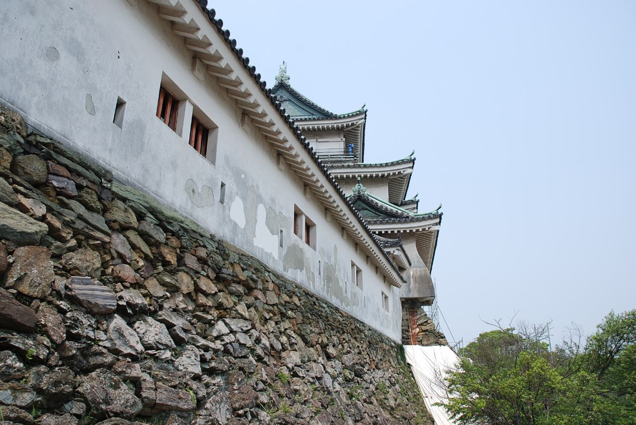 a tall brick building sitting on top of a hillside