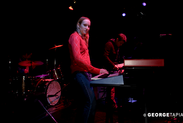 two men stand at the keyboard as they perform