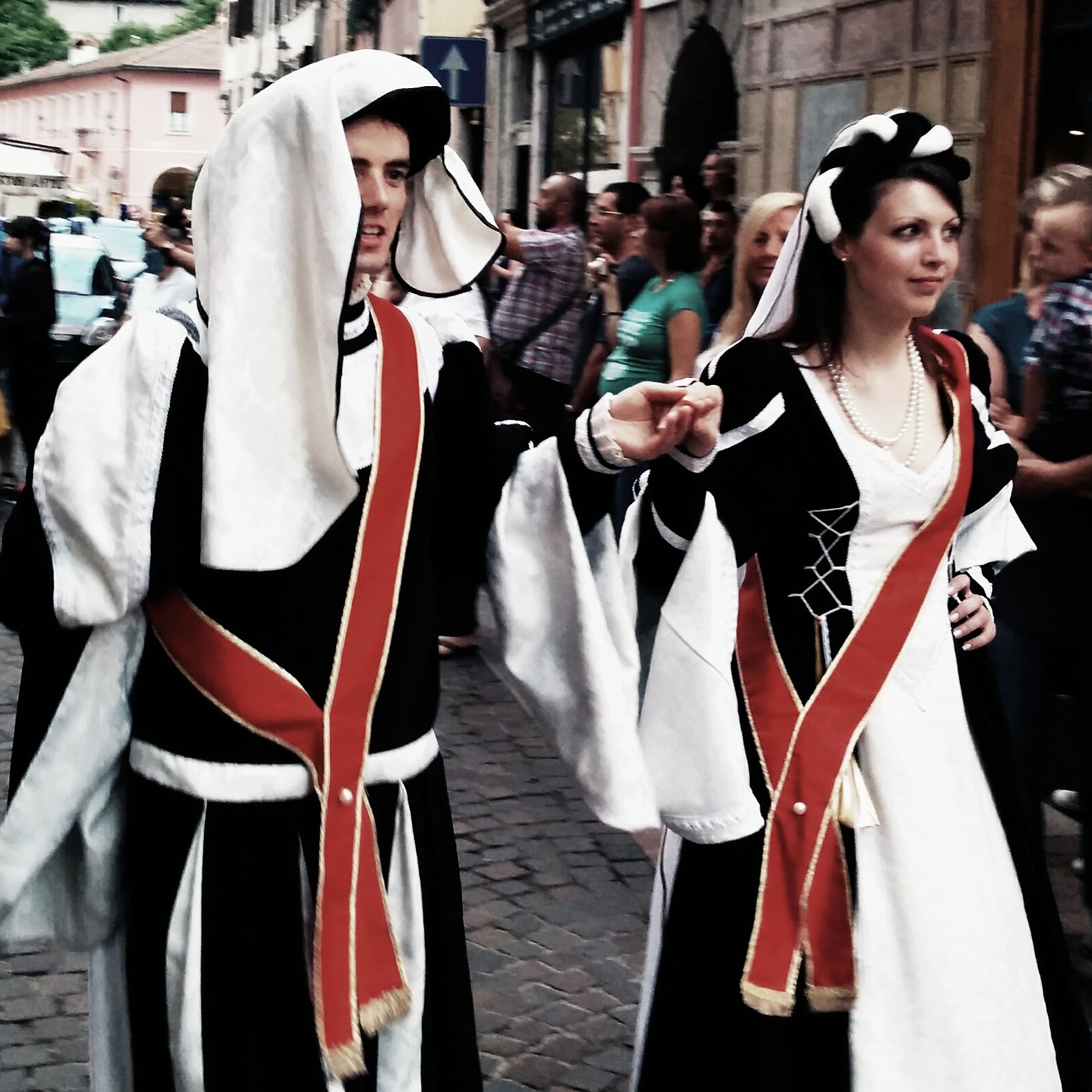 two women in costume with arms outstretched and two dressed up