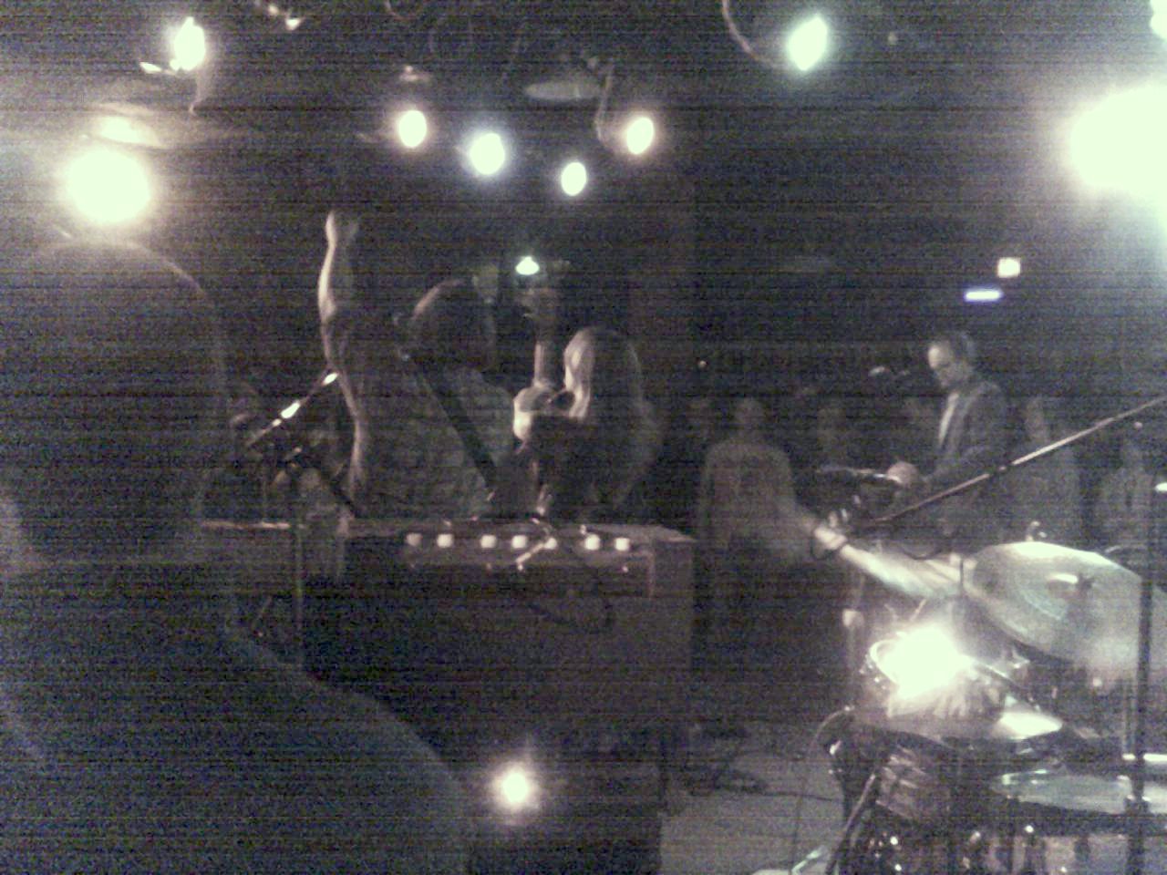 an audience watching a band on stage playing music