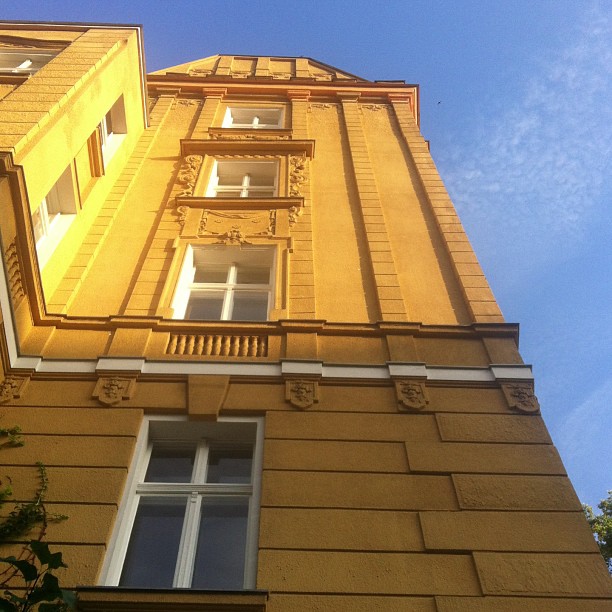 a tall yellow building with lots of windows