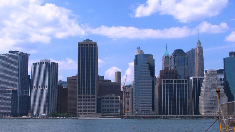 a large city skyline with some boats in the water