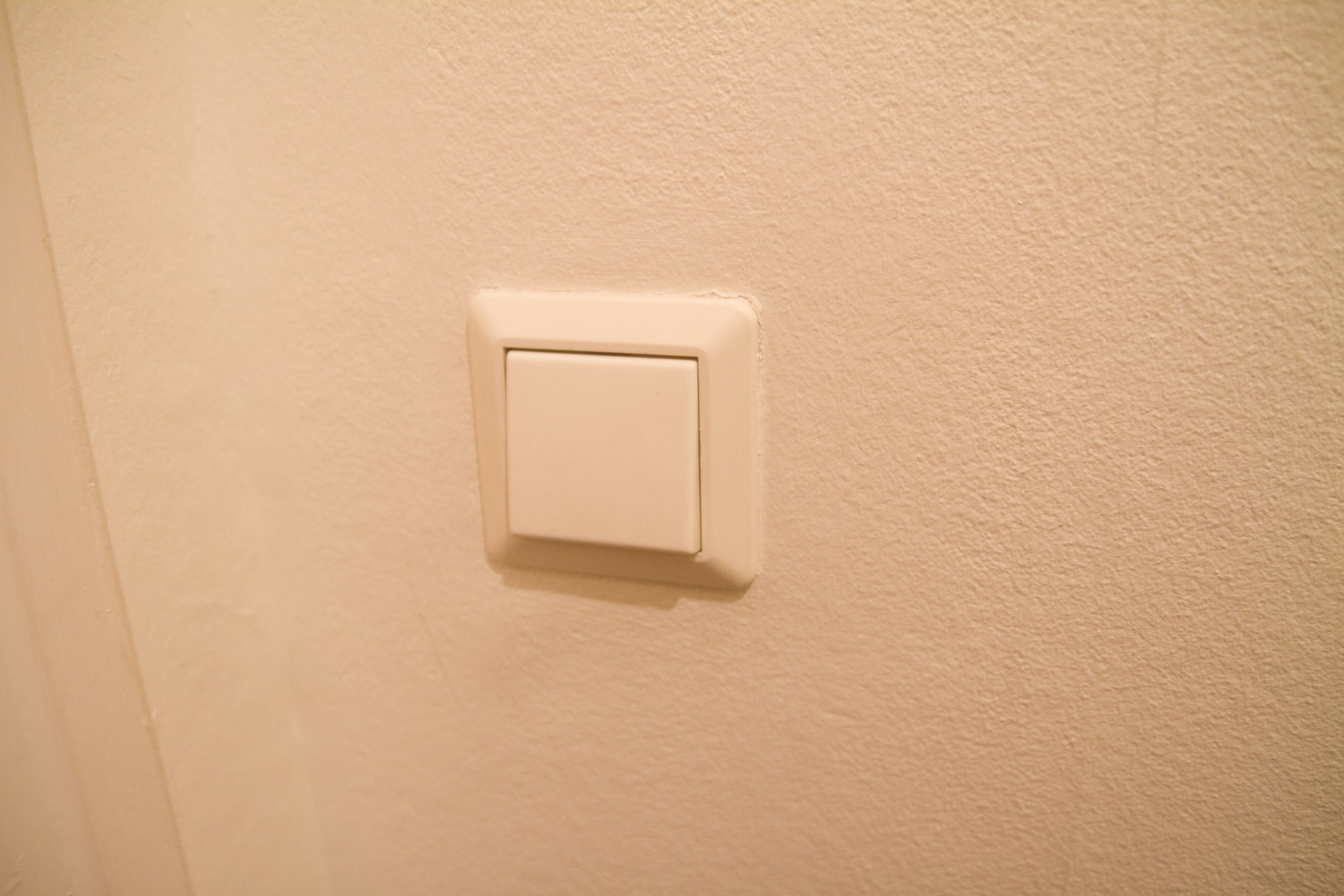 a square light switch mounted in a wall