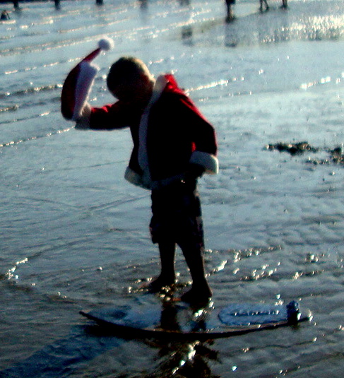 a man standing on a snowboard in the water