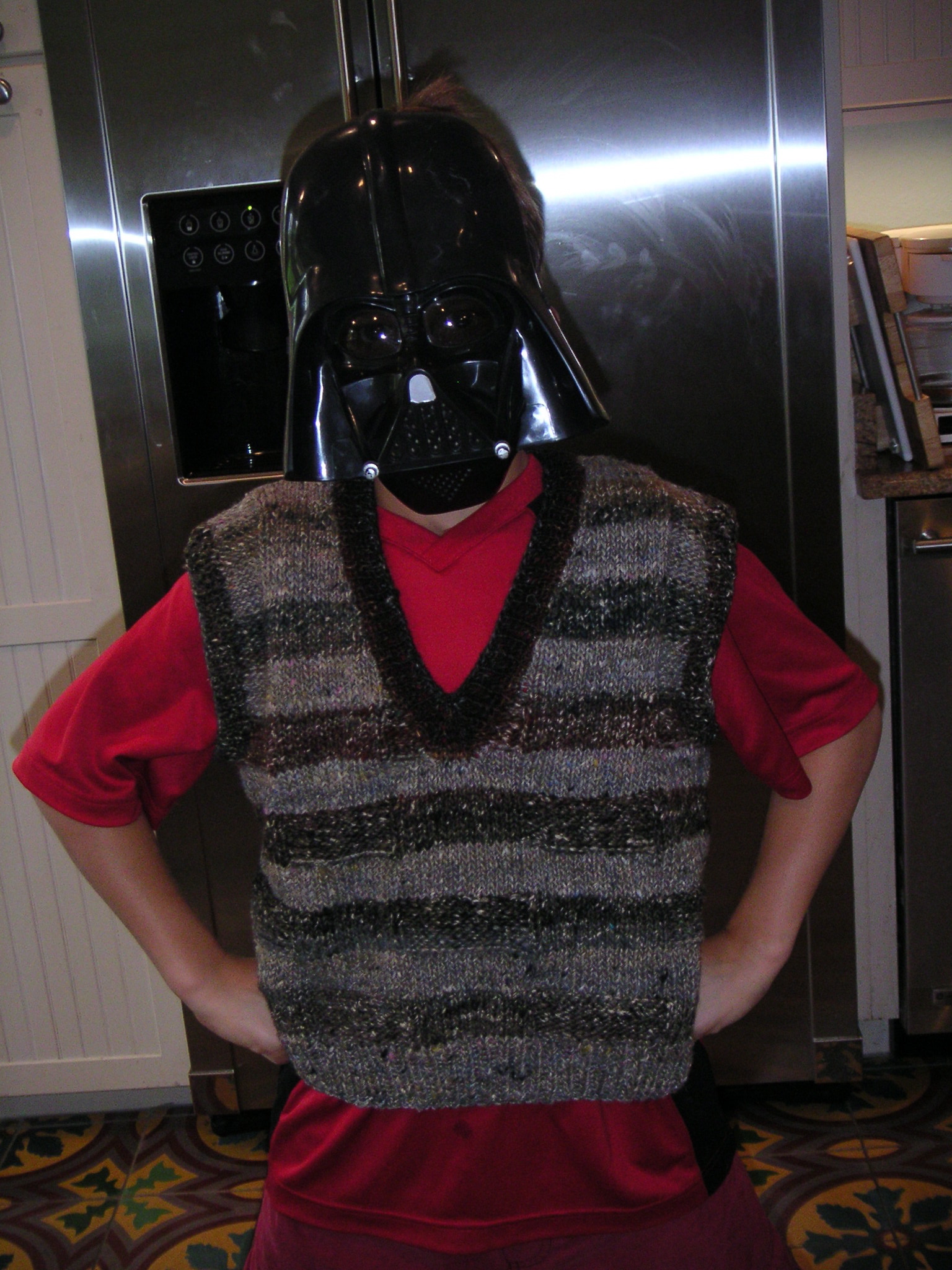 darth vader costume that is next to a refrigerator