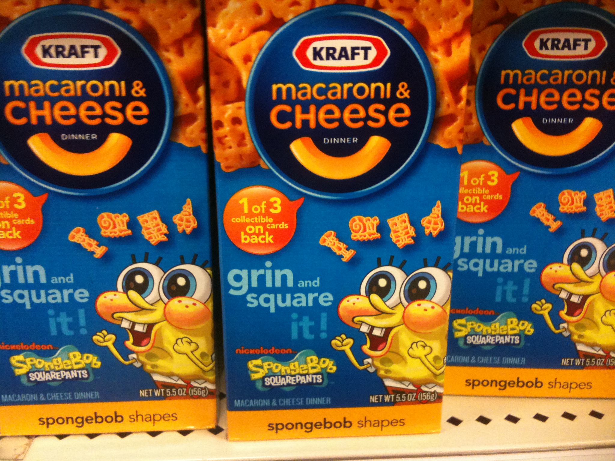 two packages of macaroni and cheese sitting in the store