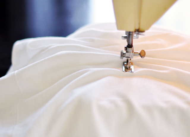a close up s of a white shirt with a sewing machine