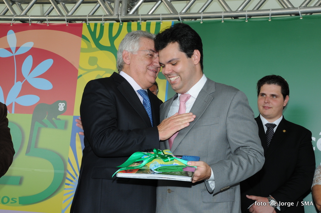 two men in business suits with a gift