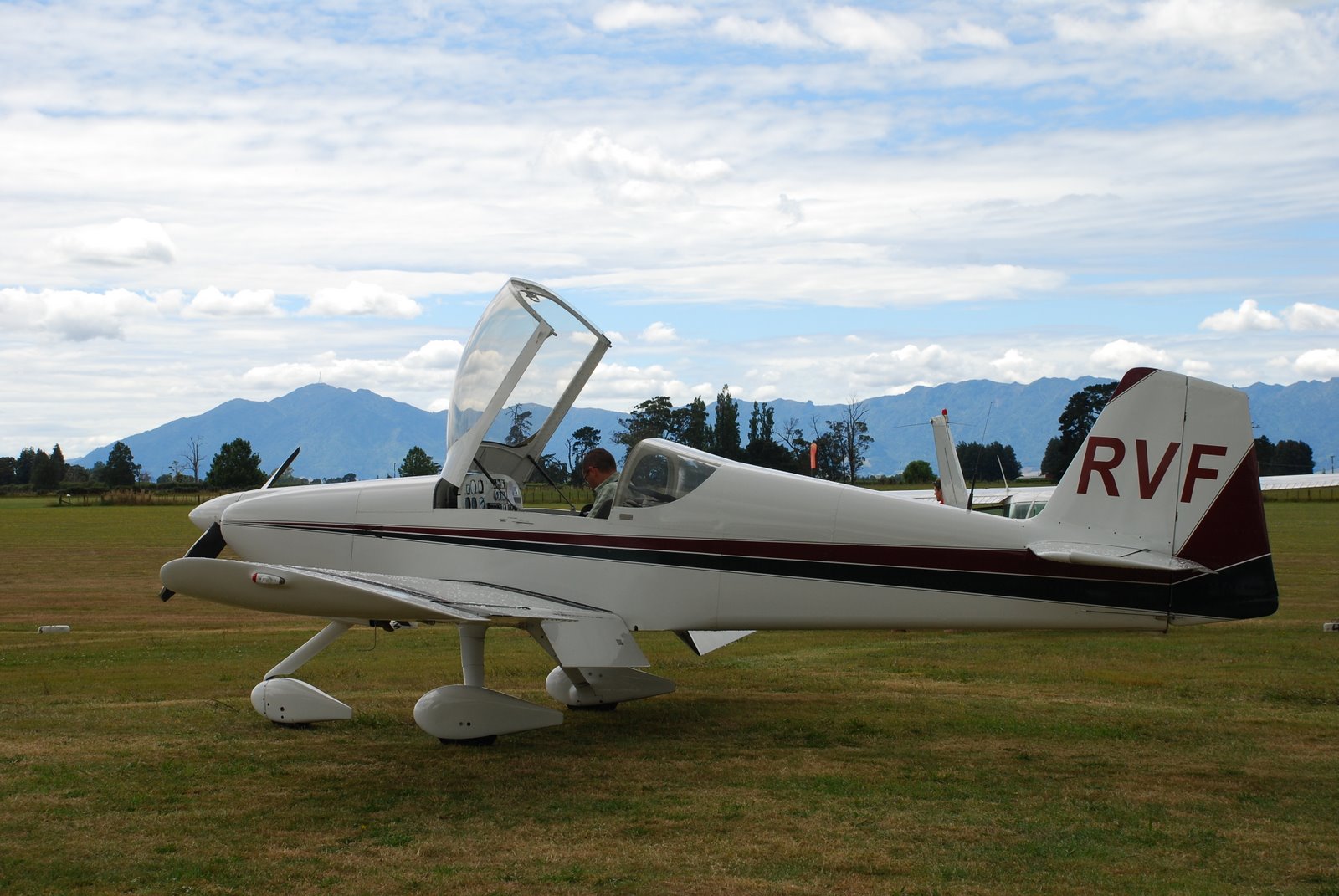 a small prop airplane is parked on the grass