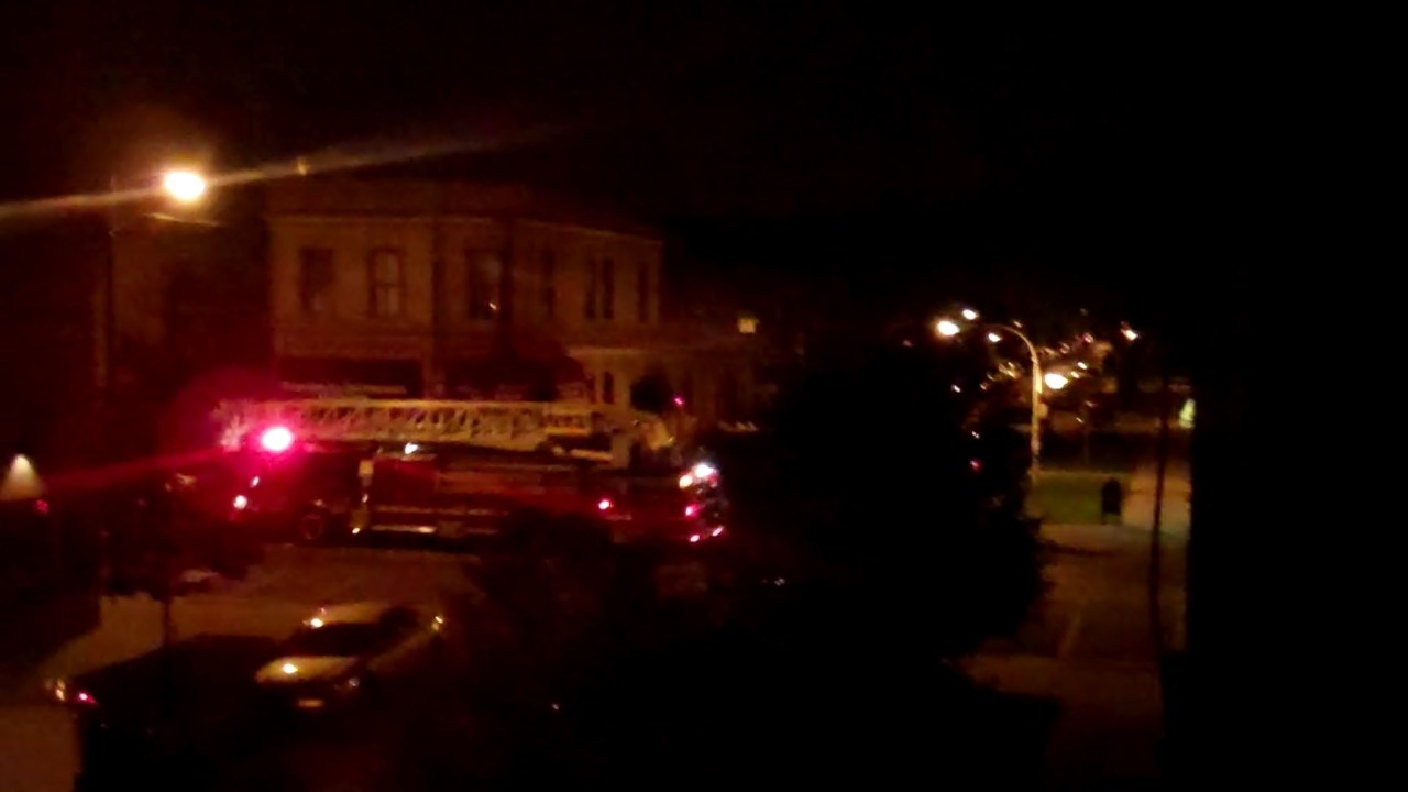 fire trucks parked in front of a large building at night