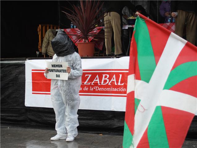 a person in a bunny suit holding soing next to two flags