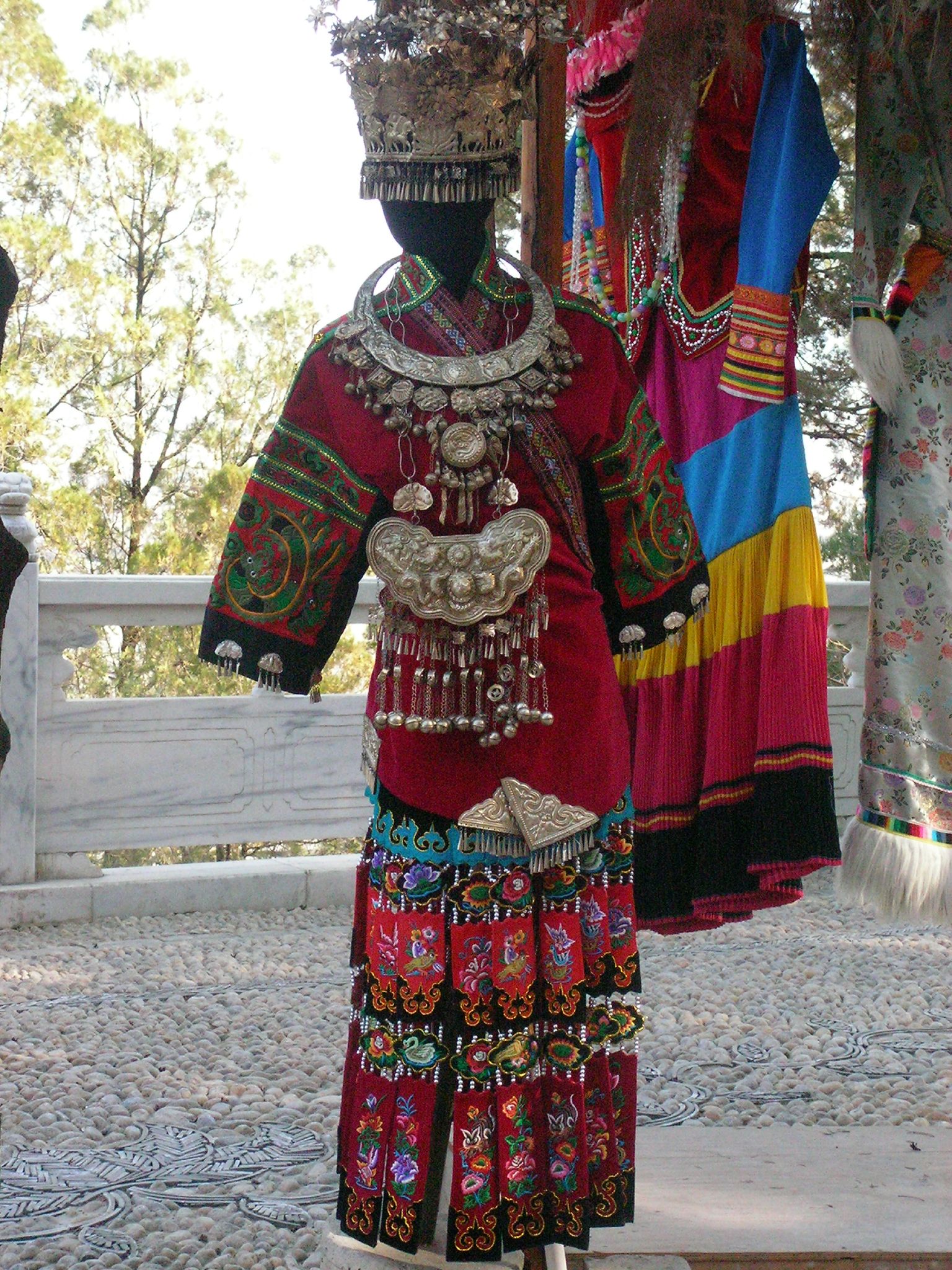 a woman in a red shirt and some colorful skirts