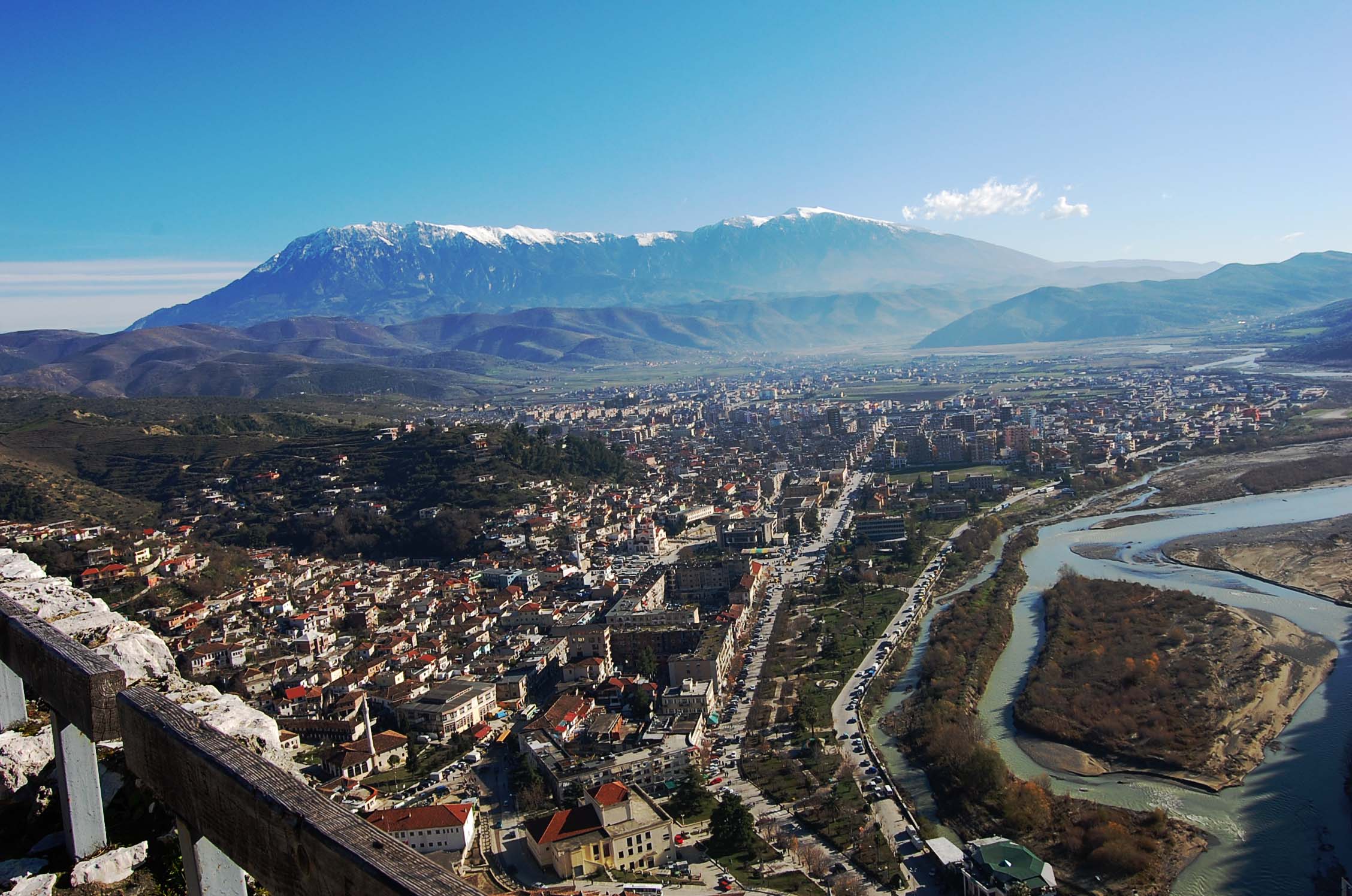 an aerial view of a city surrounded by mountains