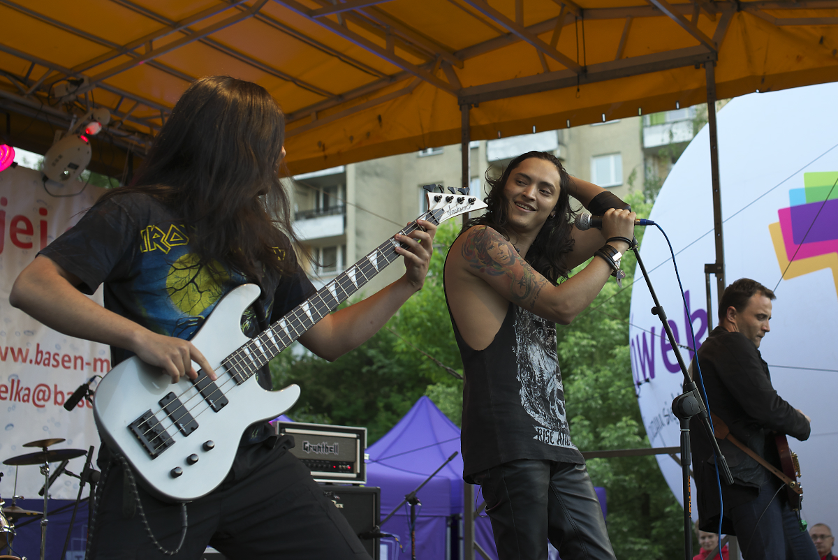 two people playing guitars at a concert