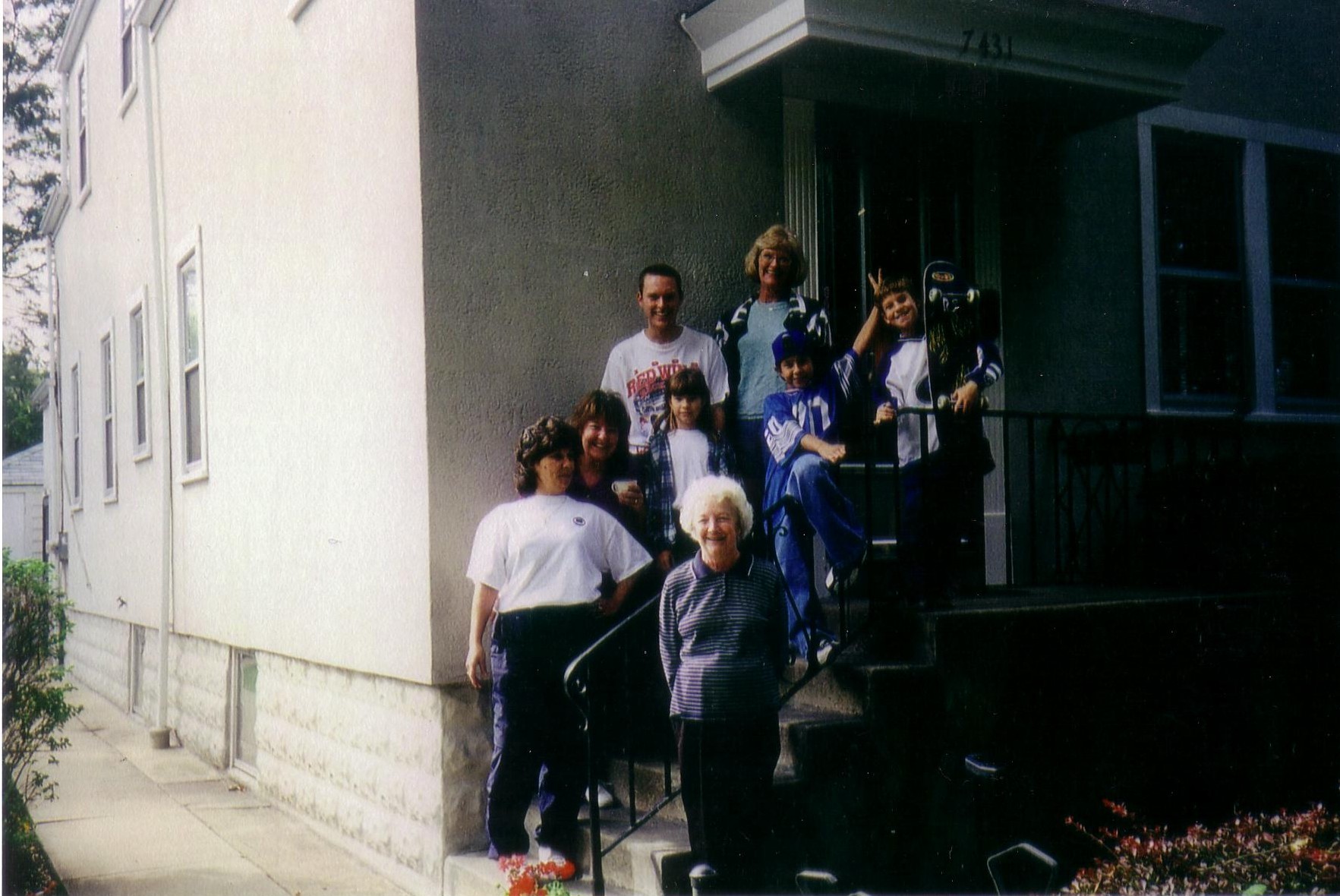 some people are standing outside on the steps outside a building