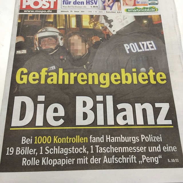 a large newspaper advertises the news for a police officers'rally