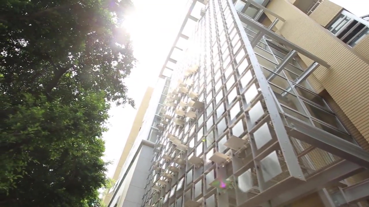 tall metal building with a silver ladder that goes down to it