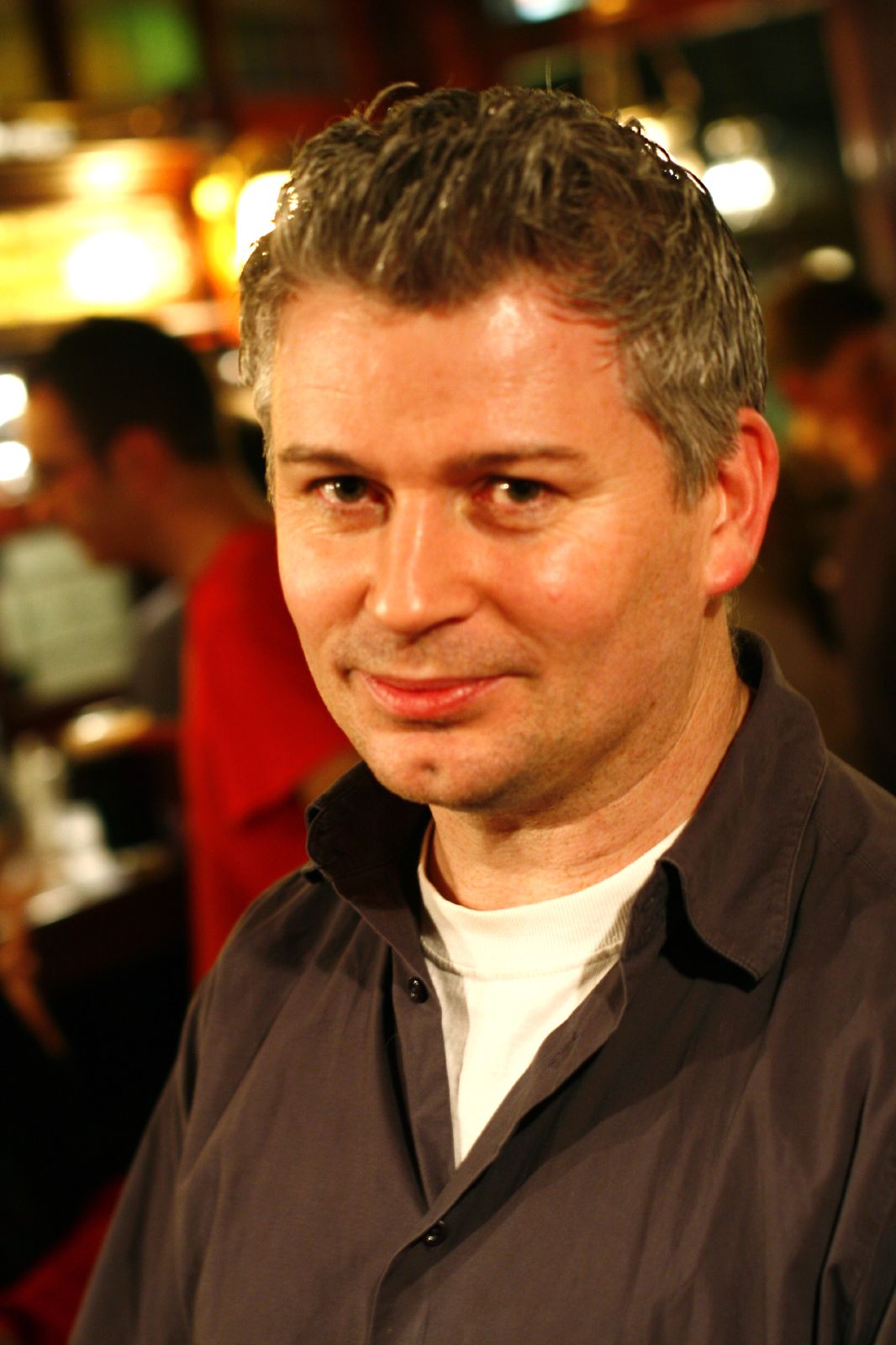 a man with short grey hair and a serious look on his face