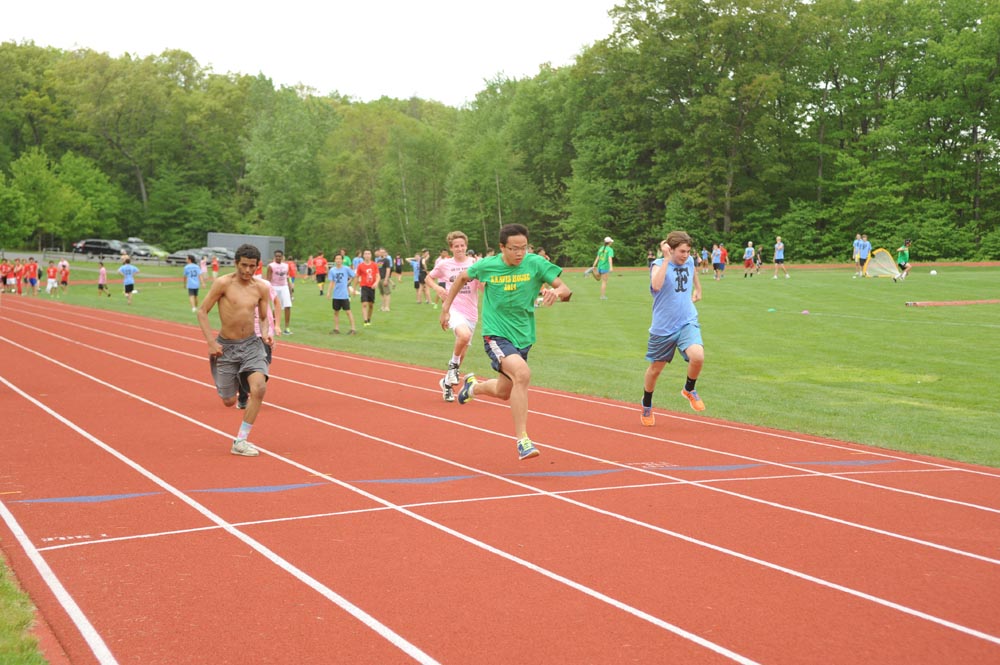 a group of young men running on a track