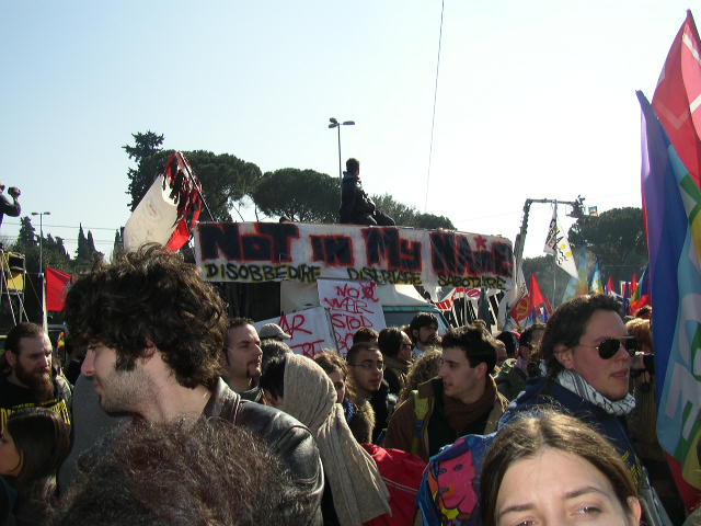 a group of people holding flags and placards