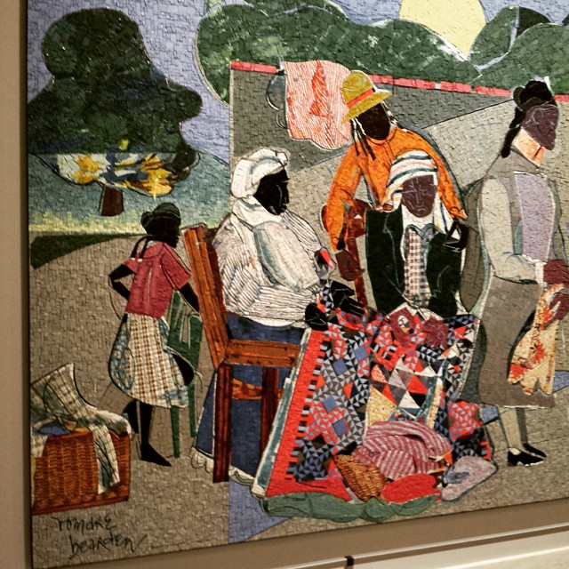 the painting on the wall depicts people having a picnic