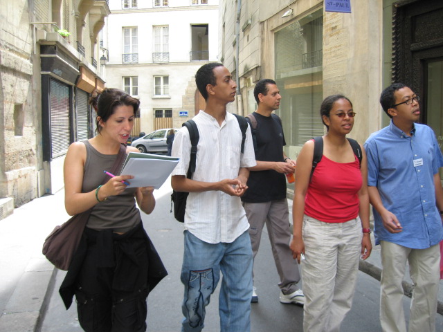 three young men and a woman talking to each other