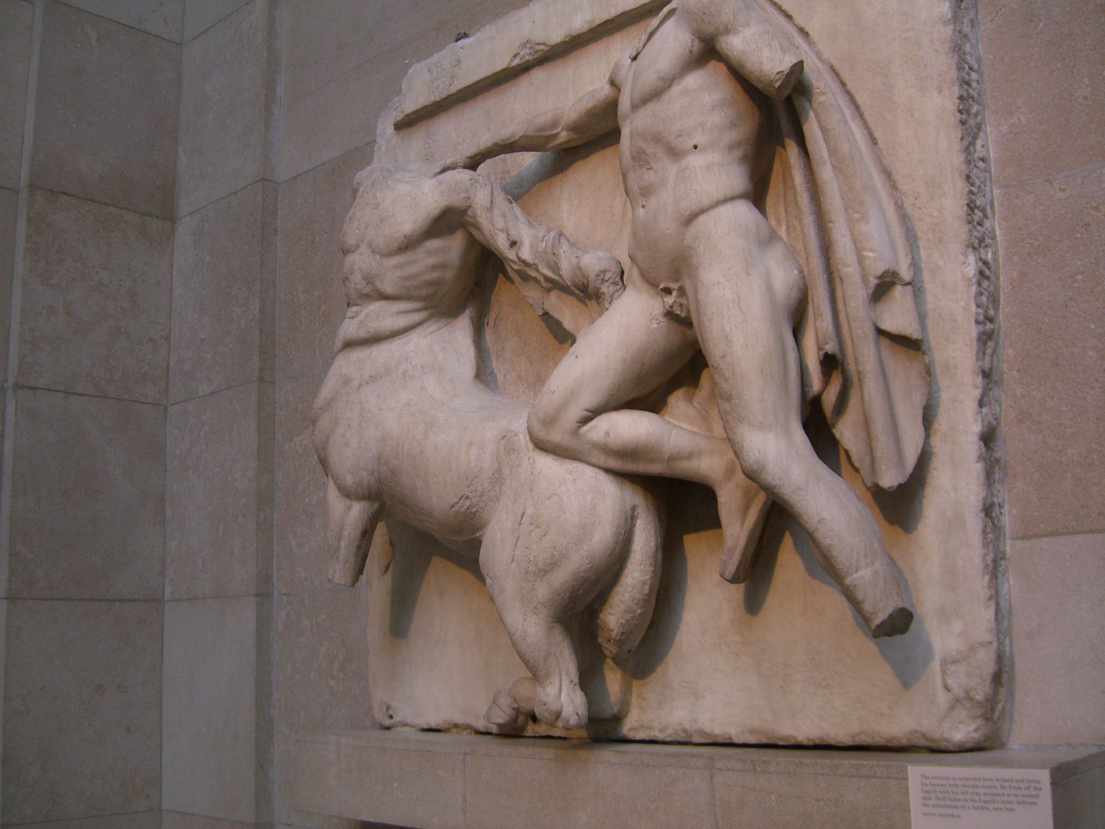 there is a large statue of a man trying to pull a man out of the back of a horse