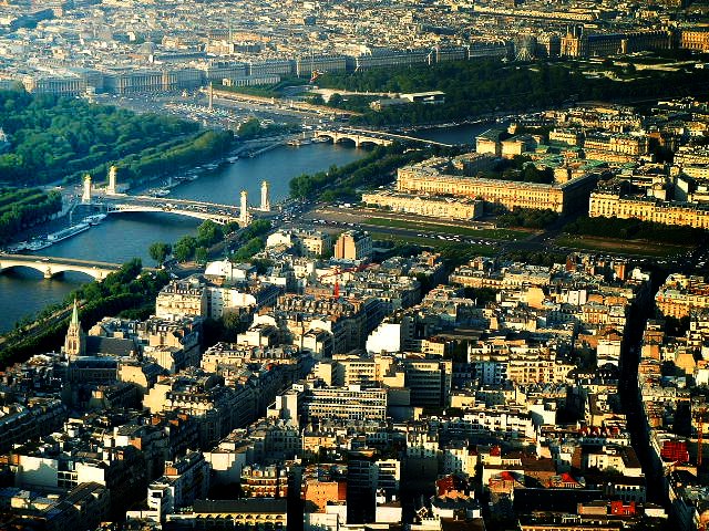 an aerial view of paris with the eiffel tower in the distance