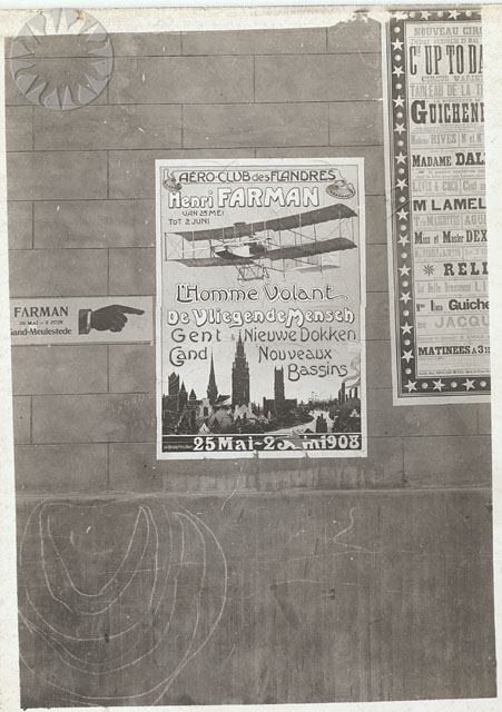 several posters on a wall near a clock