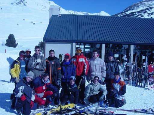 many people pose outside the ski lodge with skis on the snowy slopes