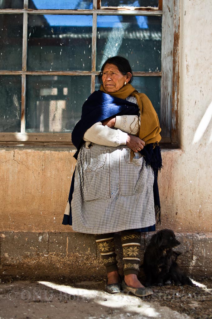 an old woman and a dog standing outside of a window