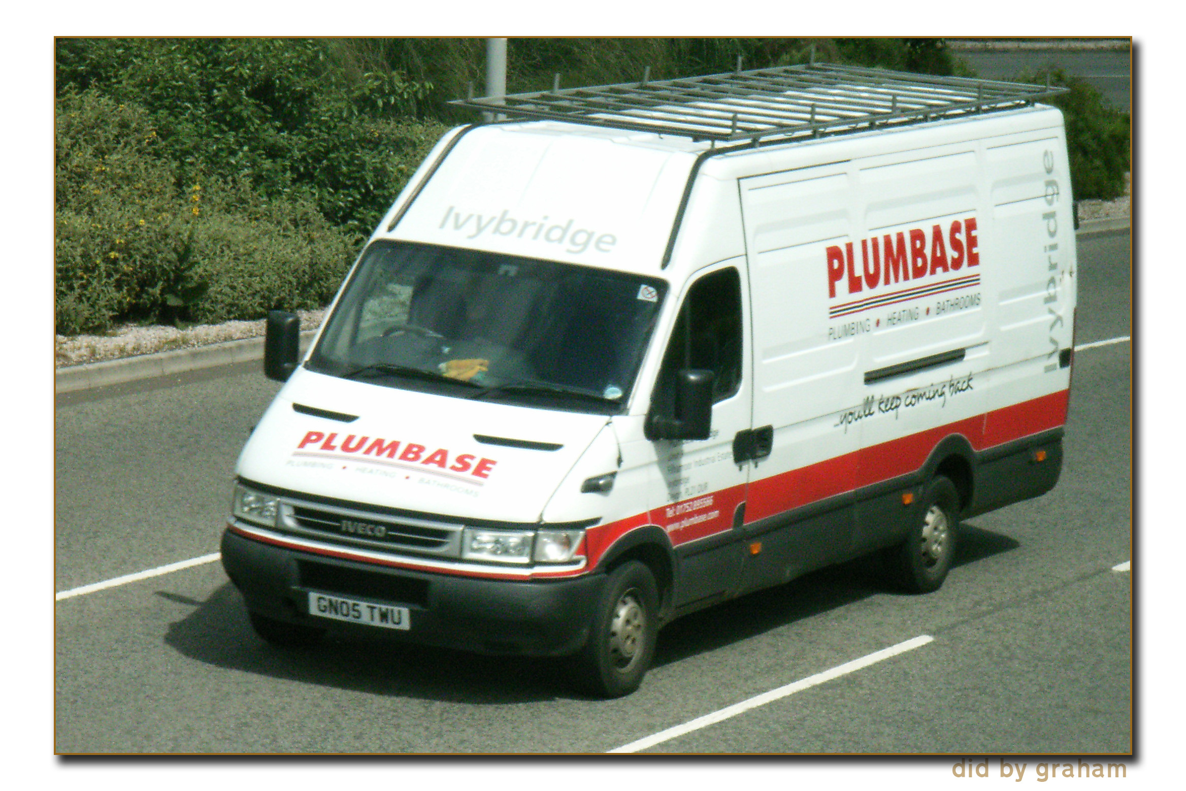 a plumbbase delivery truck driving down the street
