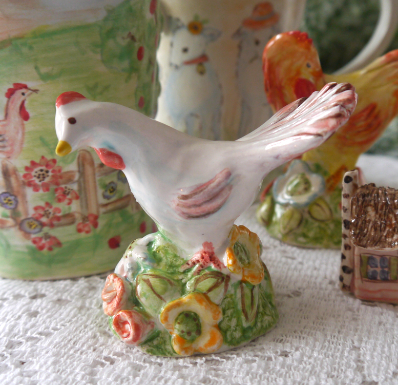 colorful rooster figurines sit atop a table