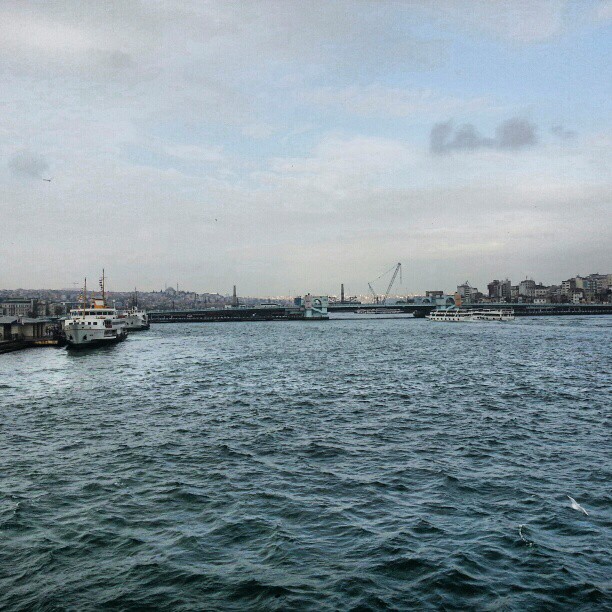 two boats are on the water next to a bridge