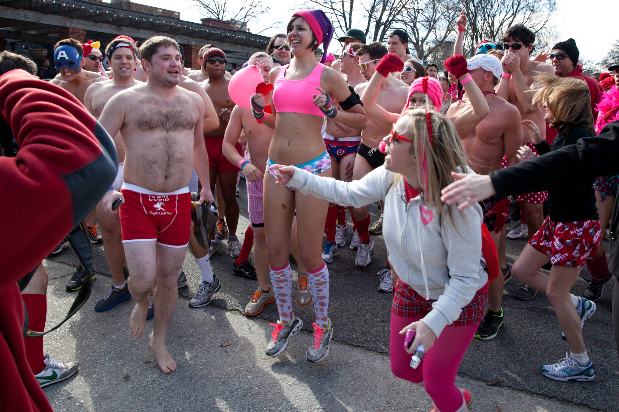 group of people in sports underwear standing on street