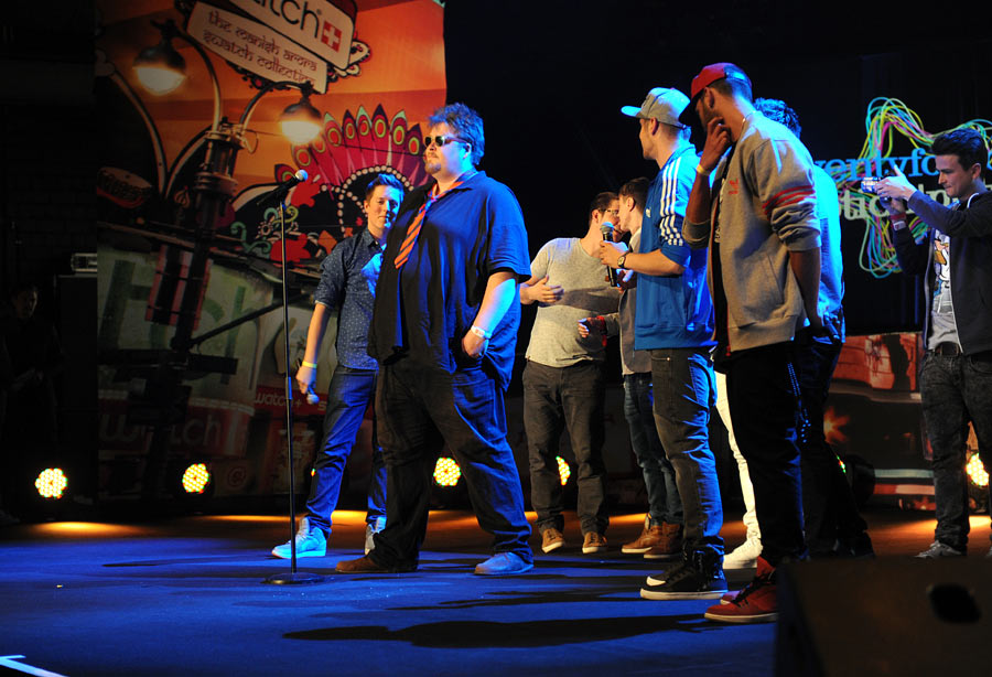 a bunch of young men singing at a concert