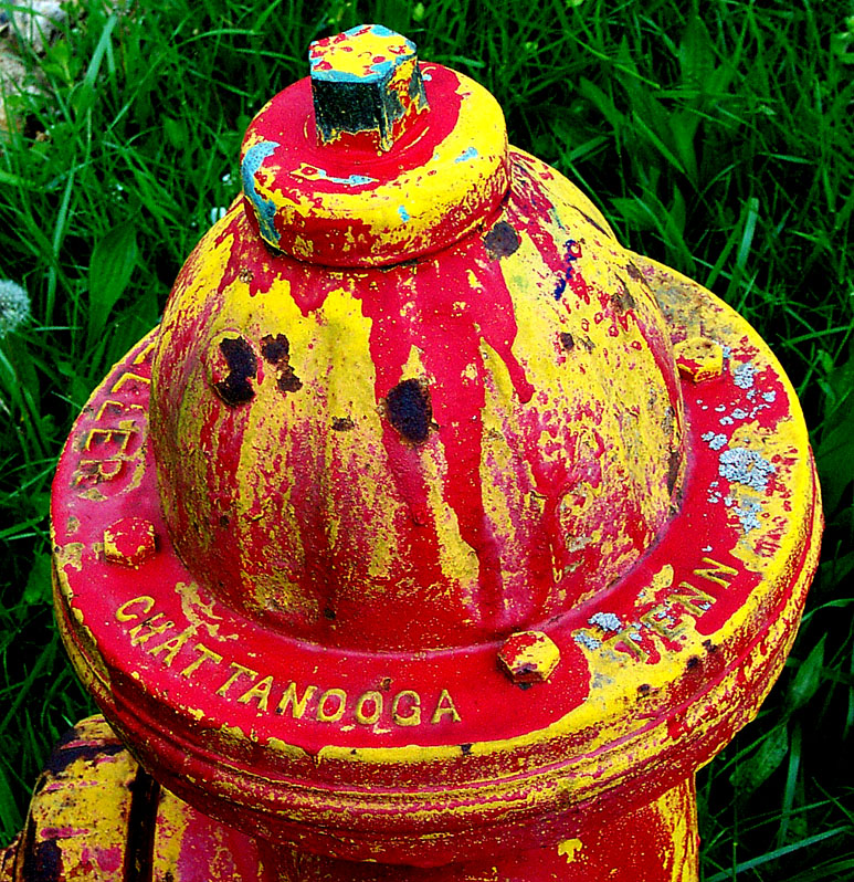 an old fire hydrant is painted yellow and red