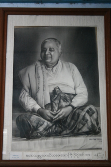 a portrait of an indian man with his hands crossed
