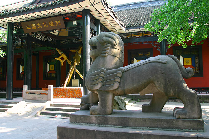 a statue in a japanese style sitting under a tree