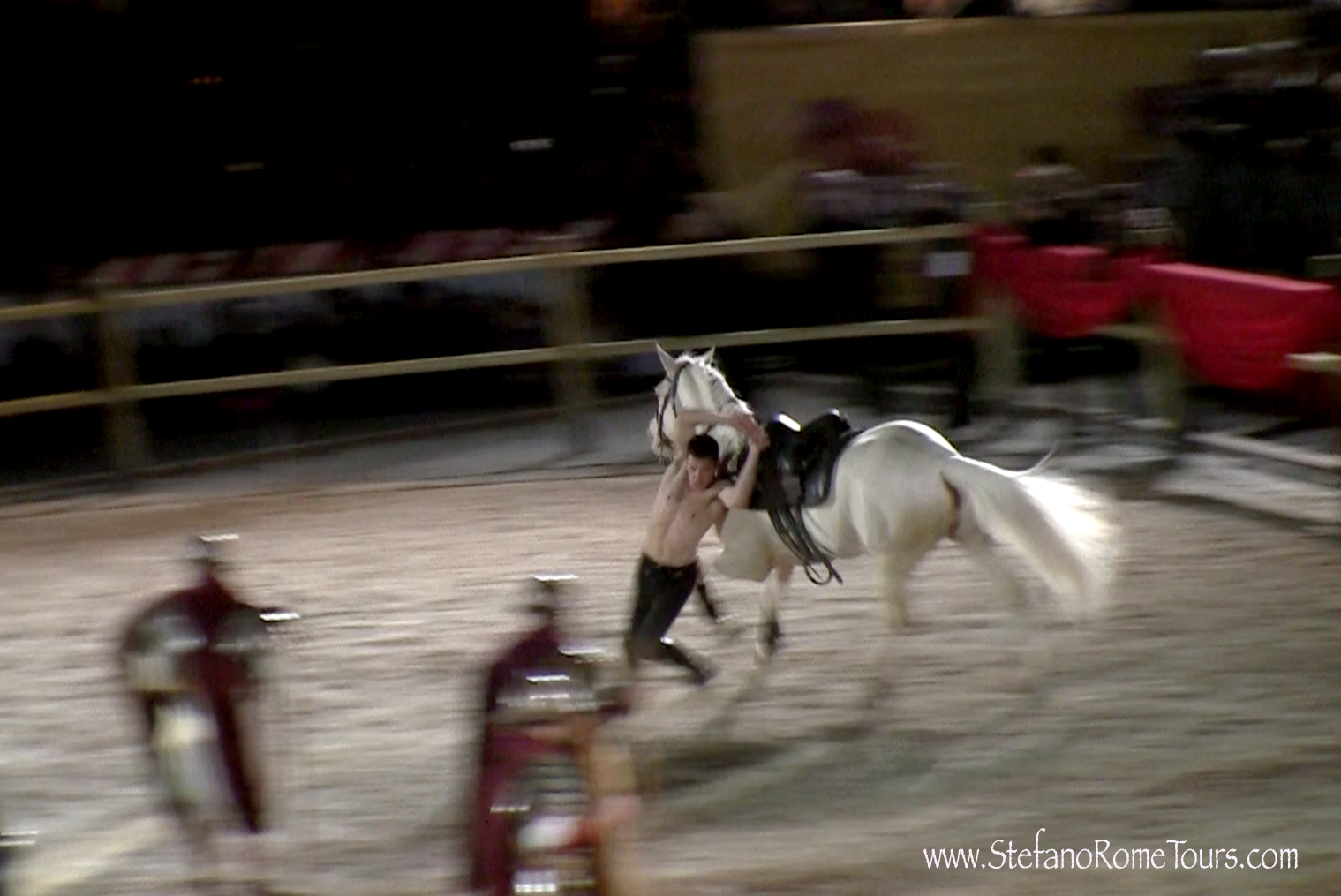 a man is on top of a horse in an arena