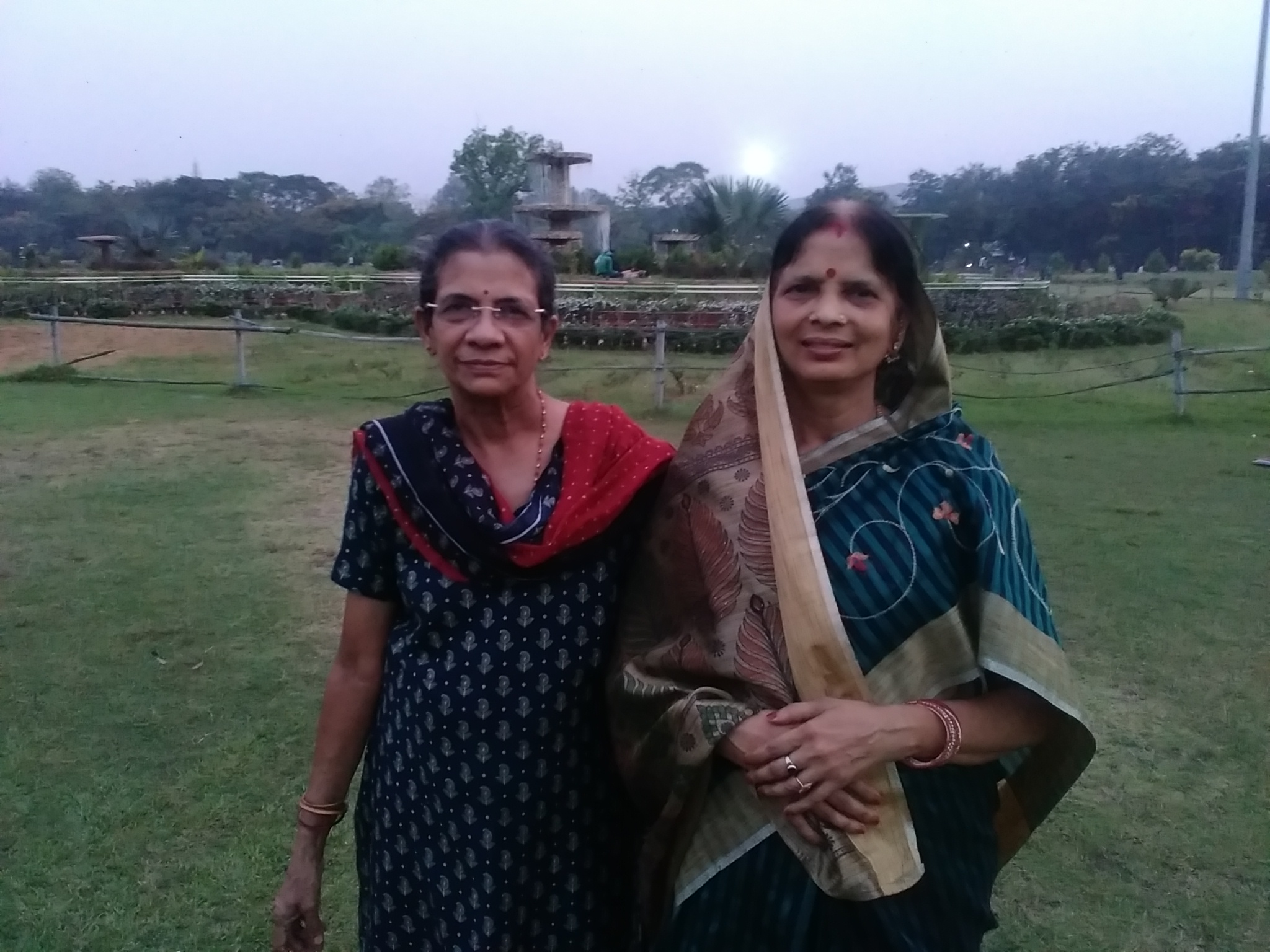 two women who are standing in a field