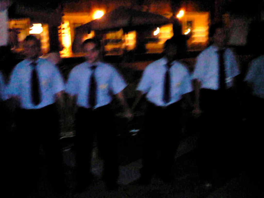 a group of men standing together while one is holding soing