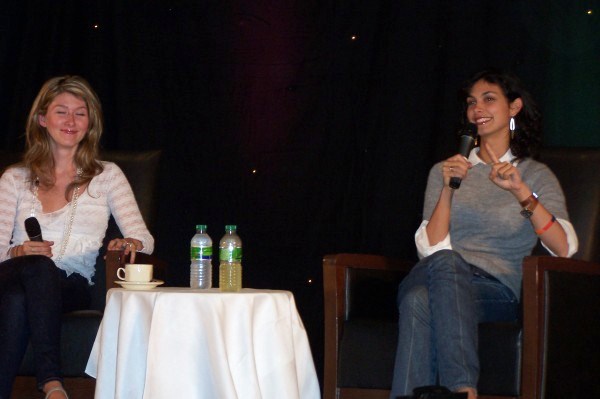 two women talking at a panel event
