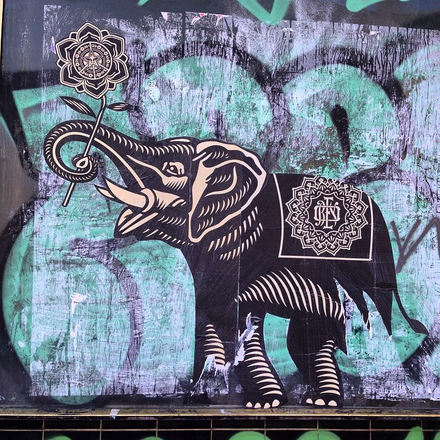 a colorful painted elephant on a wall