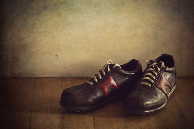 black, brown and red leather shoes on the floor