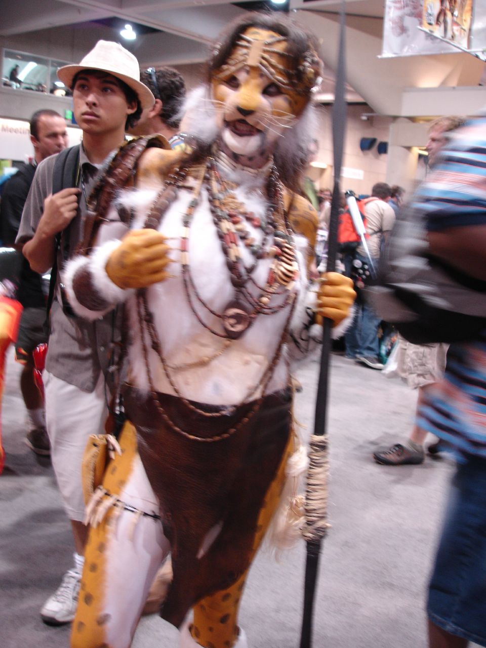 a person in costume standing next to a pole
