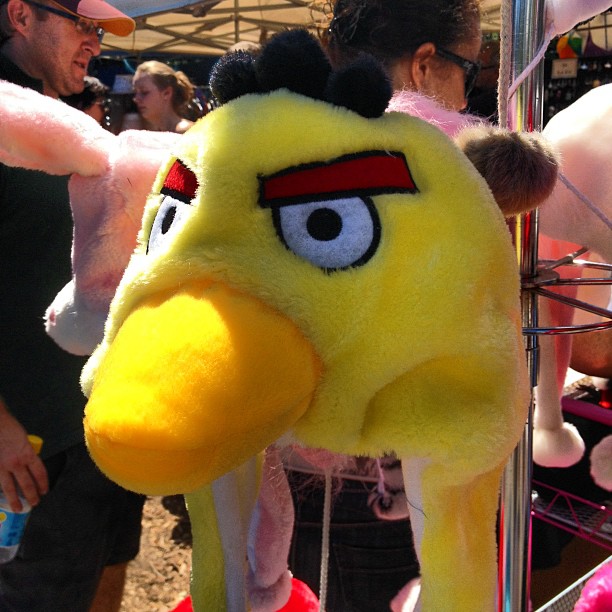 yellow cartoon bird mascot with an eye at fair