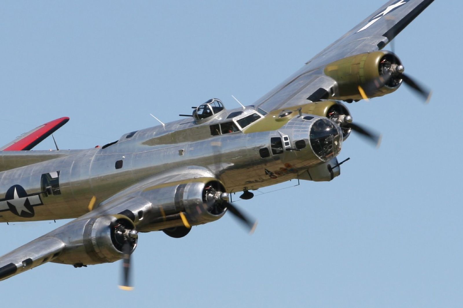 an airplane with two propellers is flying in the air